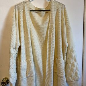Cute woman’s cardigan with puff sleeves.
